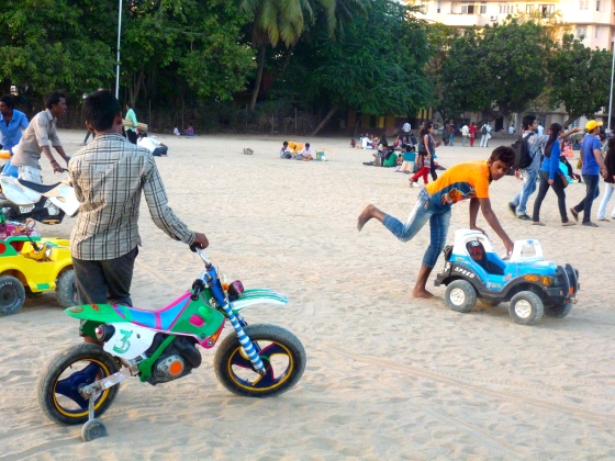 The "rides"... guys pushing kids around on toys